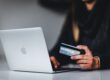 Woman shopping online with bank card
