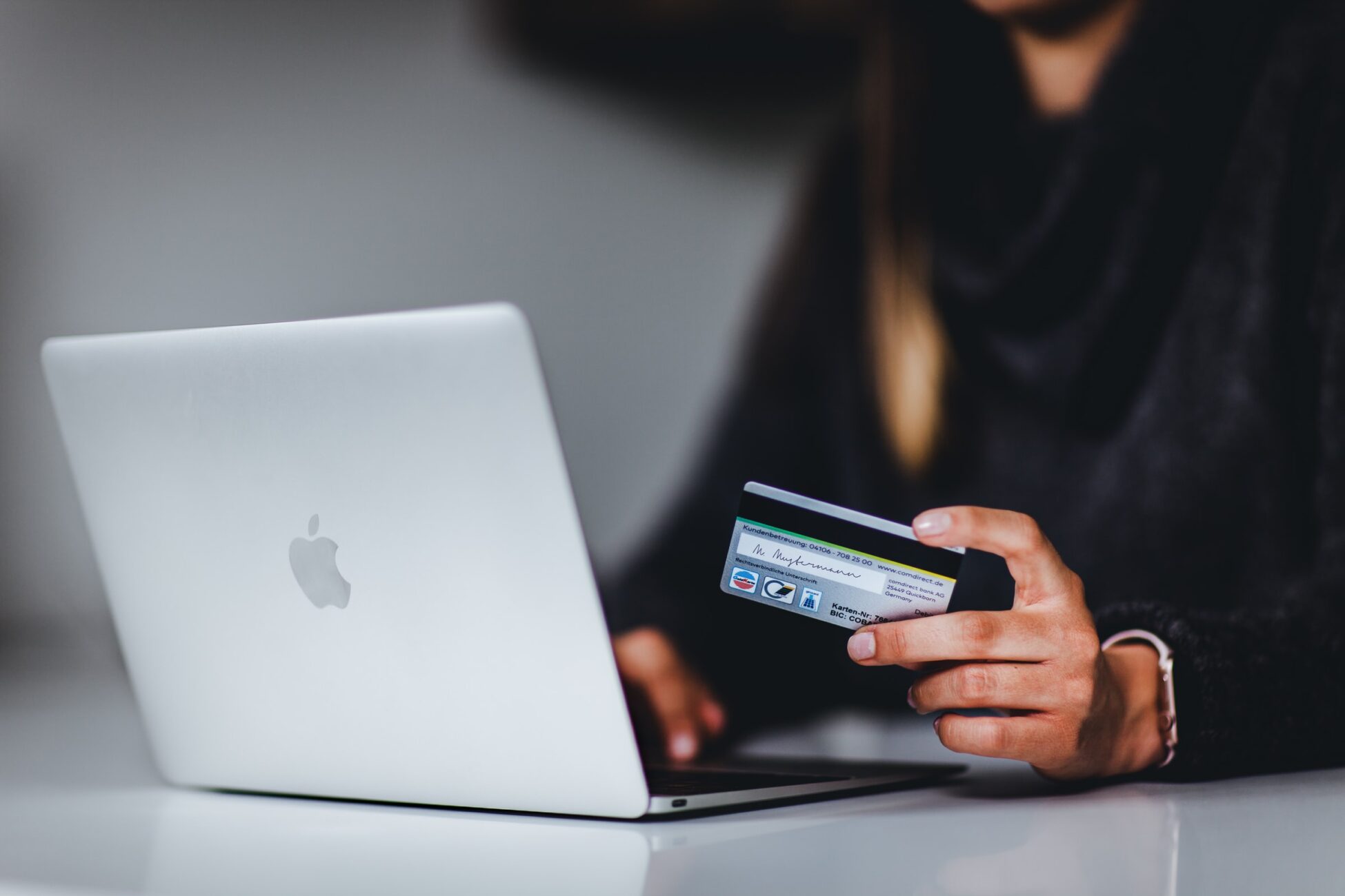 Woman shopping online with bank card